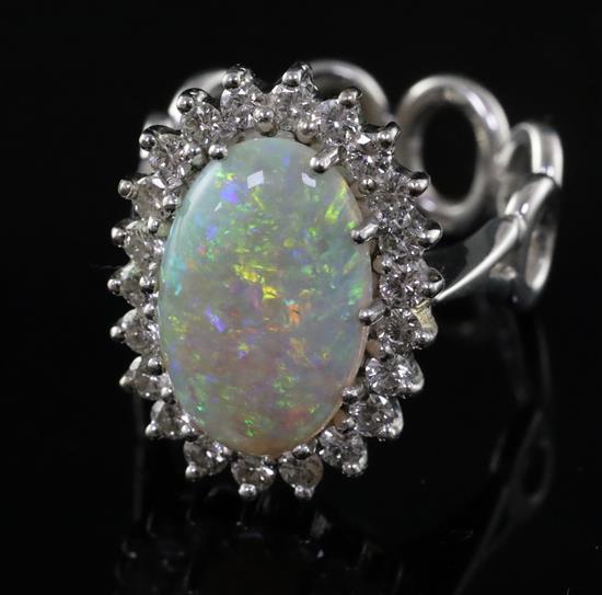 A modern 18ct white gold, white opal and diamond oval cluster ring, size L.